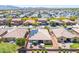 Aerial view of backyards with green grass, patio sets, and some with solar panels at 15704 W Taylor St, Goodyear, AZ 85338