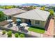 Inviting backyard with well-maintained turf, patio with seating area, and privacy fence perfect for outdoor relaxation and entertaining at 15704 W Taylor St, Goodyear, AZ 85338
