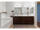 Large main bathroom with double sinks and vanities, perfect for a couple or Gathering at 15704 W Taylor St, Goodyear, AZ 85338