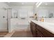 Elegant bathroom featuring double sinks, lots of light and a shower and bathtub at 15704 W Taylor St, Goodyear, AZ 85338