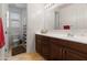 Well-lit bathroom showcasing a modern vanity, ample storage, and a combined shower and toilet area at 15704 W Taylor St, Goodyear, AZ 85338