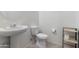 Half bathroom with a pedestal sink and modern fixtures at 15704 W Taylor St, Goodyear, AZ 85338