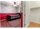 Cozy bedroom featuring hardwood floors, a ceiling fan, and closet access for convenient storage at 15704 W Taylor St, Goodyear, AZ 85338