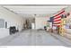 Spacious two car garage with ample room for storage with installed shelving units at 15704 W Taylor St, Goodyear, AZ 85338