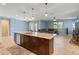 Stylish kitchen showcases a large center island, perfect for entertaining, with views into the adjacent living space at 15704 W Taylor St, Goodyear, AZ 85338