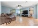 Comfortable living room with a large, comfortable sofa, ceiling fan, tile floors, and plenty of natural light at 15704 W Taylor St, Goodyear, AZ 85338