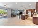 Open-concept living space featuring a modern kitchen island, comfortable seating, and sliding glass doors to the backyard at 15704 W Taylor St, Goodyear, AZ 85338