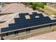 A view of a house roof with solar panels and outdoor sitting area at 15704 W Taylor St, Goodyear, AZ 85338