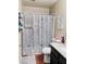 Cozy bathroom with a shower-tub combo, decorative shower curtain, and granite vanity top at 1616 W Burgess Ln, Phoenix, AZ 85041