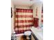 Cozy bathroom with a shower-tub combo, decorative shower curtain, and granite vanity top at 1616 W Burgess Ln, Phoenix, AZ 85041
