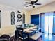 A dining room area featuring a ceiling fan and black wood table and chairs at 1616 W Burgess Ln, Phoenix, AZ 85041
