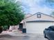 Charming single-story home with a two-car garage, desert landscaping and a mature shade tree at 1616 W Burgess Ln, Phoenix, AZ 85041