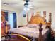 Spacious bedroom features a decorative king bed, ceiling fan, and neutral wall colors at 1616 W Burgess Ln, Phoenix, AZ 85041