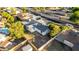 An aerial view of this homes shows a manicured lawn, desert landscape, and nearby community features at 1644 W Thunderbird Rd, Phoenix, AZ 85023
