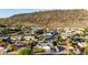 Stunning aerial view of a peaceful neighborhood nestled against a mountain with lush green trees and blue skies at 1644 W Thunderbird Rd, Phoenix, AZ 85023