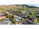 Aerial view of a neighborhood with lush trees, roads, and mountains in the background at 1644 W Thunderbird Rd, Phoenix, AZ 85023