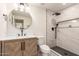 Bathroom showcasing a modern vanity, decorative mirror, toilet, and shower with stylish tile at 1644 W Thunderbird Rd, Phoenix, AZ 85023