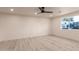 Well-lit, spacious bedroom with a modern ceiling fan and a large window offering outdoor views at 1644 W Thunderbird Rd, Phoenix, AZ 85023