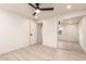 Bright bedroom featuring ceiling fan, closet with mirrored doors and a view into bathroom at 1644 W Thunderbird Rd, Phoenix, AZ 85023