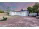 Exterior of the home includes a spacious backyard with gravel landscape with a bright dusk sky overhead at 1644 W Thunderbird Rd, Phoenix, AZ 85023