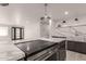 Gourmet kitchen island with seating, quartz countertops, cooktop, and stylish pendant lighting, ideal for entertaining at 1644 W Thunderbird Rd, Phoenix, AZ 85023