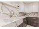 Stylish farmhouse sink featuring quartz countertops with new dark cabinets and modern fixtures at 1644 W Thunderbird Rd, Phoenix, AZ 85023