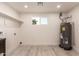 Laundry room with utility sink, storage shelf, and hot water tank at 1644 W Thunderbird Rd, Phoenix, AZ 85023
