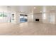Bright living room with wood floors, a modern fireplace, and a sliding glass door providing backyard views at 1644 W Thunderbird Rd, Phoenix, AZ 85023