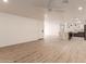 Open-concept living room featuring hardwood floors, recessed lighting, and a seamless transition to the kitchen at 1644 W Thunderbird Rd, Phoenix, AZ 85023
