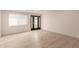 Bright, neutral living space with modern wood-look flooring and a stylish glass-panel front door at 1644 W Thunderbird Rd, Phoenix, AZ 85023