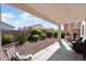 Backyard featuring desert landscaping and covered patio area, perfect for outdoor relaxation and entertaining at 17611 W Ingleside Dr, Surprise, AZ 85374