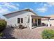 Inviting outdoor space with a covered patio, dining set and desert landscaping at 17611 W Ingleside Dr, Surprise, AZ 85374
