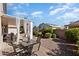 Outdoor patio with dining set and lounge area, offering a comfortable space for enjoying the landscaped backyard at 17611 W Ingleside Dr, Surprise, AZ 85374
