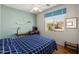 Bright bedroom features a large window for natural light and a comfortable bed, creating a cozy atmosphere at 17611 W Ingleside Dr, Surprise, AZ 85374