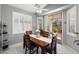 Bright dining room with wood table, white shutters, and sliding glass door to patio at 17611 W Ingleside Dr, Surprise, AZ 85374