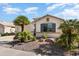 Inviting single-story home featuring desert landscaping, palm trees, and a neutral color scheme at 17611 W Ingleside Dr, Surprise, AZ 85374