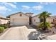 Single-story home with a two-car garage and desert landscaping for low maintenance at 17611 W Ingleside Dr, Surprise, AZ 85374