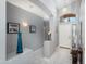 Elegant hallway with gray walls, tiled floors, and stylish decor at 17611 W Ingleside Dr, Surprise, AZ 85374