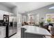 Bright kitchen features stainless steel appliances, gray island, and smooth countertops at 17611 W Ingleside Dr, Surprise, AZ 85374