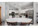 Modern kitchen featuring white cabinets, stainless steel appliances, and a breakfast bar at 17611 W Ingleside Dr, Surprise, AZ 85374