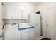 Functional laundry room with washer, dryer, and ample storage cabinets for convenience and organization at 17611 W Ingleside Dr, Surprise, AZ 85374