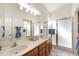 Main bathroom features double sinks, modern vanity, and glass shower enclosure at 17611 W Ingleside Dr, Surprise, AZ 85374