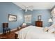 Cozy main bedroom with soft blue walls, wood floors, and bright natural light at 17611 W Ingleside Dr, Surprise, AZ 85374