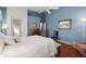 Serene main bedroom boasting blue walls, wood floors, and bright natural light at 17611 W Ingleside Dr, Surprise, AZ 85374