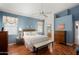Main bedroom with blue walls, hardwood floors, and calming natural light at 17611 W Ingleside Dr, Surprise, AZ 85374
