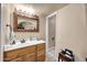 Bathroom featuring a vanity with framed mirror, decorative lighting, and tiled flooring at 17705 E Canyon Way, Gilbert, AZ 85298