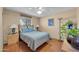 Bedroom with hardwood floors, a ceiling fan, and natural light from the window at 17705 E Canyon Way, Gilbert, AZ 85298