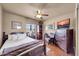 Comfortable bedroom with hardwood floors, ceiling fan, and natural light at 17705 E Canyon Way, Gilbert, AZ 85298
