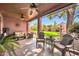 Relaxing covered patio with comfortable seating, ceiling fans, and view of landscaped backyard at 17705 E Canyon Way, Gilbert, AZ 85298