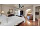 Comfortable primary suite with wood floors, a ceiling fan, and ensuite bath at 17705 E Canyon Way, Gilbert, AZ 85298